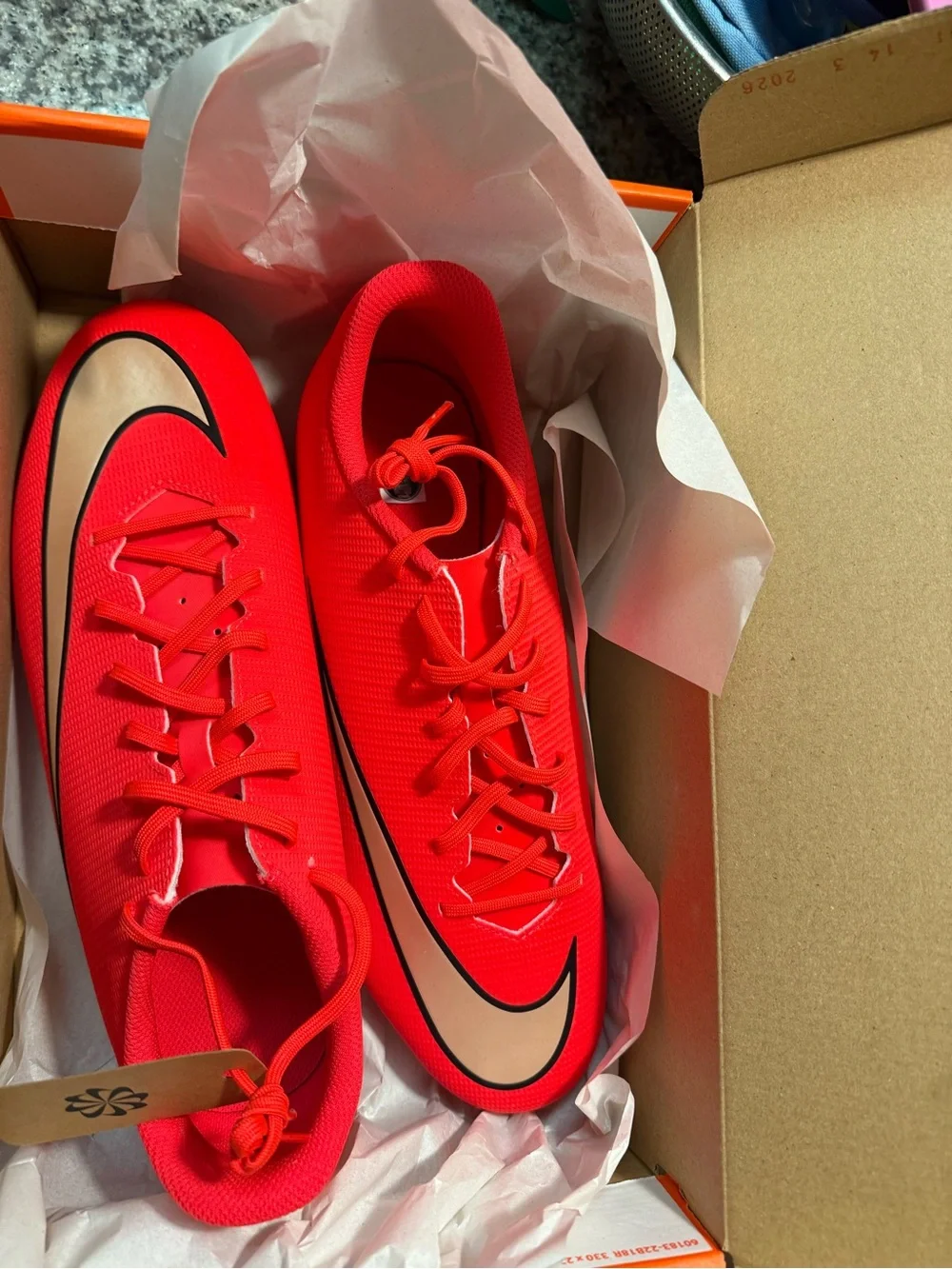 Nike Women’s Red Soccer Cleats with Gold Swoosh Accent